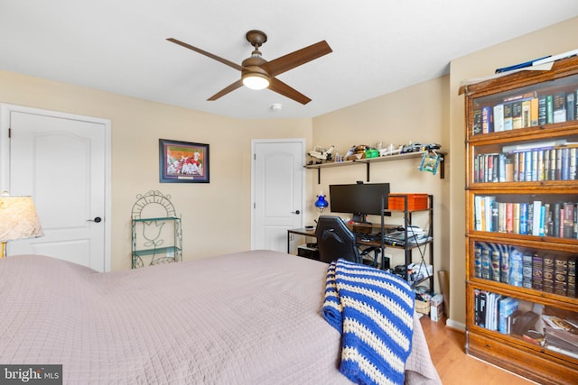 bedroom with light hardwood / wood-style flooring and ceiling fan