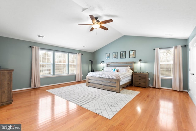 bedroom featuring ceiling fan, light hardwood / wood-style flooring, and lofted ceiling