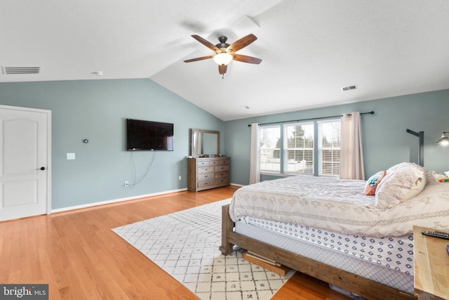 bedroom featuring hardwood / wood-style floors, vaulted ceiling, and ceiling fan