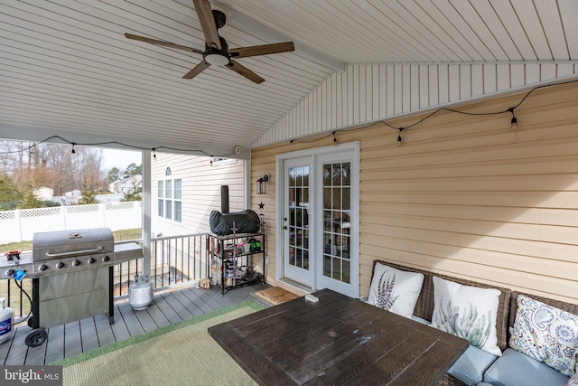 wooden terrace featuring french doors, ceiling fan, and grilling area