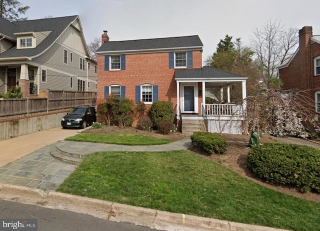 view of front of house featuring a front yard and covered porch