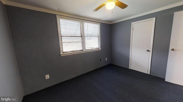 unfurnished bedroom with ceiling fan and dark carpet