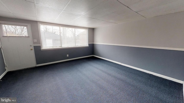 empty room with carpet flooring and a drop ceiling