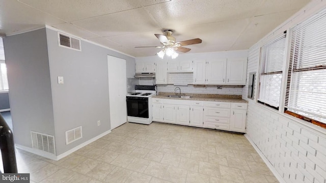 kitchen featuring sink, white cabinetry, white range with gas cooktop, ceiling fan, and backsplash