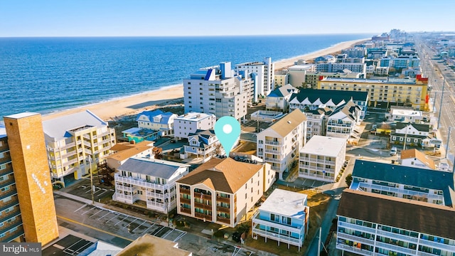 drone / aerial view with a beach view and a water view