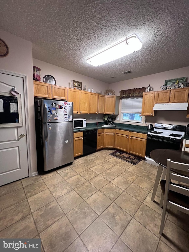 kitchen with sink, stainless steel fridge, black dishwasher, range with gas stovetop, and a textured ceiling