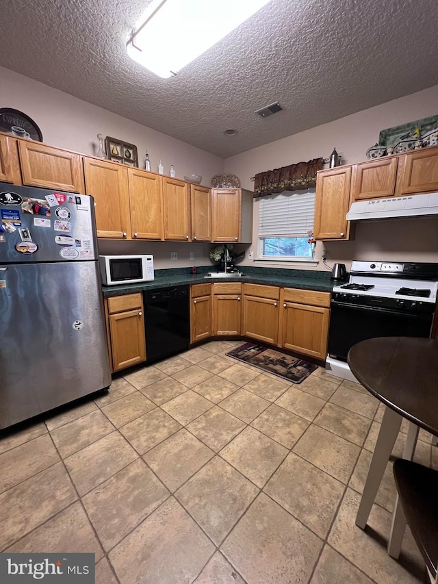 kitchen with sink, range, a textured ceiling, stainless steel refrigerator, and black dishwasher