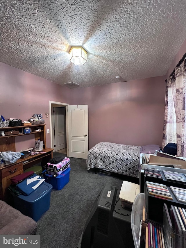 carpeted bedroom featuring a textured ceiling