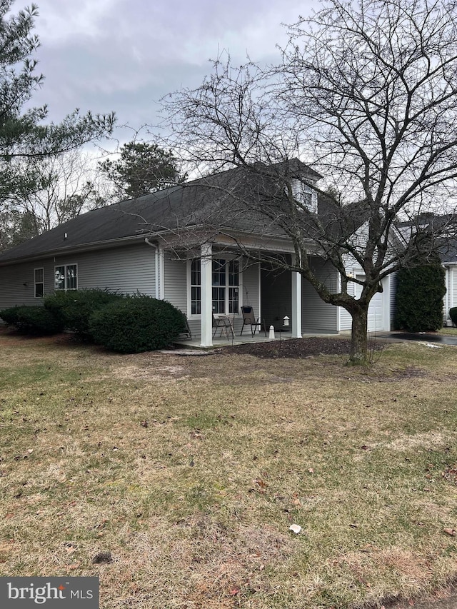 view of front of house with a patio and a front lawn