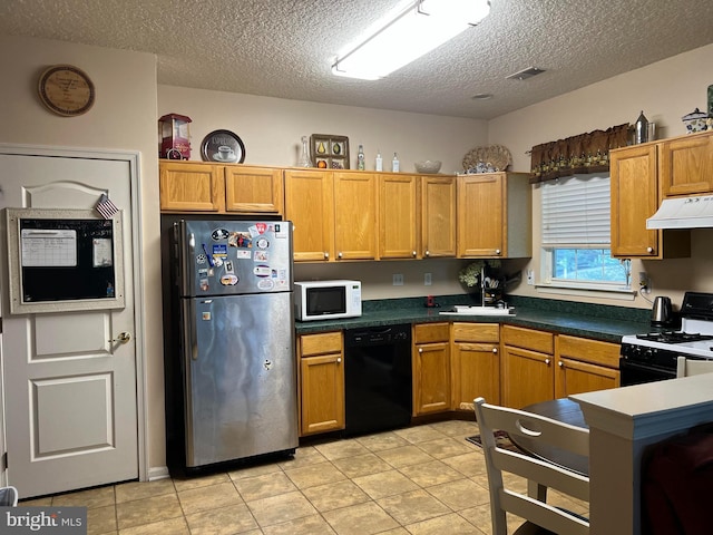 kitchen with sink, light tile patterned floors, a textured ceiling, and black appliances