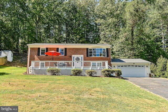 bi-level home featuring a wooden deck, a garage, and a front lawn