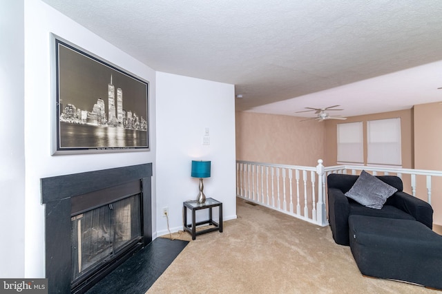 living area with carpet flooring and a textured ceiling