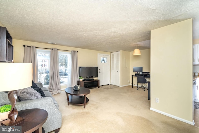 living room with light colored carpet and a textured ceiling