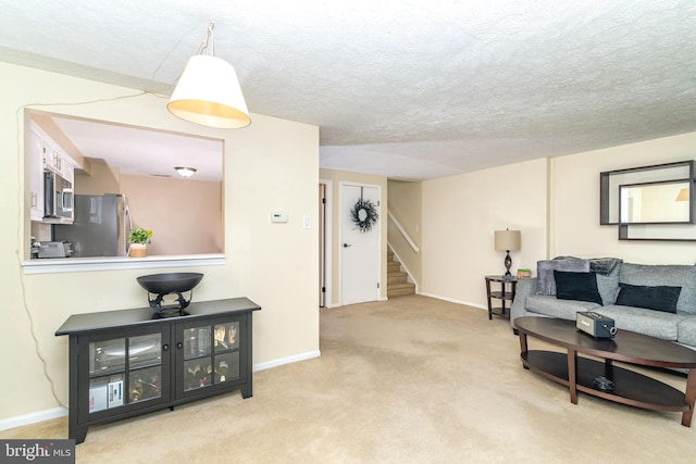 carpeted living room featuring a textured ceiling