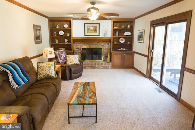 living room with crown molding, plenty of natural light, and a fireplace