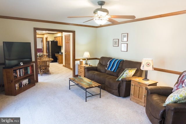 carpeted living room featuring crown molding and ceiling fan