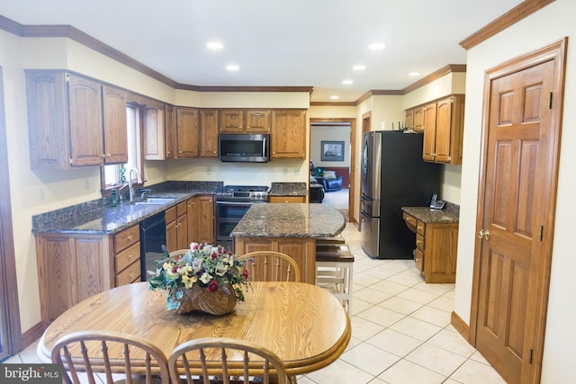 kitchen featuring light tile patterned flooring, sink, ornamental molding, a center island, and stainless steel appliances