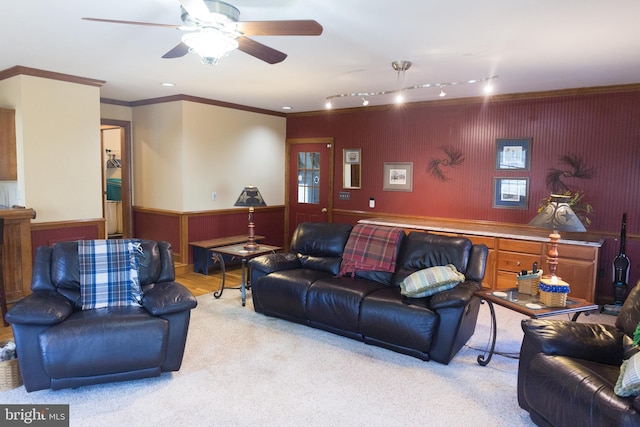 living room with crown molding, rail lighting, light colored carpet, and ceiling fan