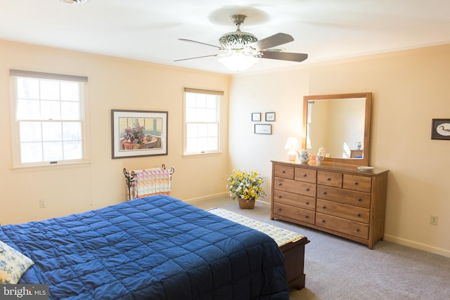 carpeted bedroom with multiple windows, ornamental molding, and ceiling fan