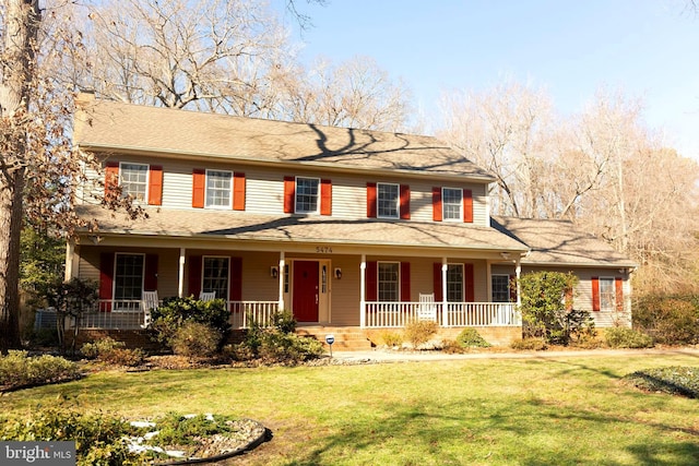 view of front of home featuring covered porch and a front yard