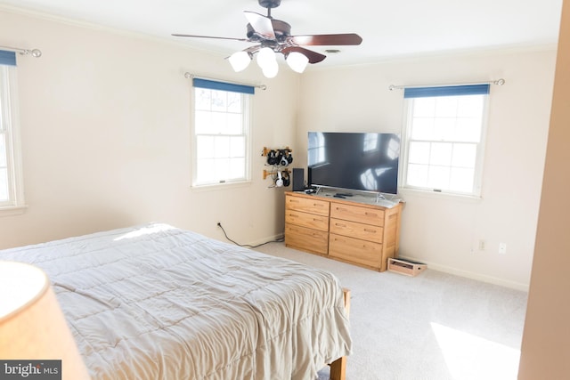 bedroom with crown molding, ceiling fan, and light carpet