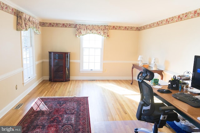 office featuring light hardwood / wood-style floors and a healthy amount of sunlight