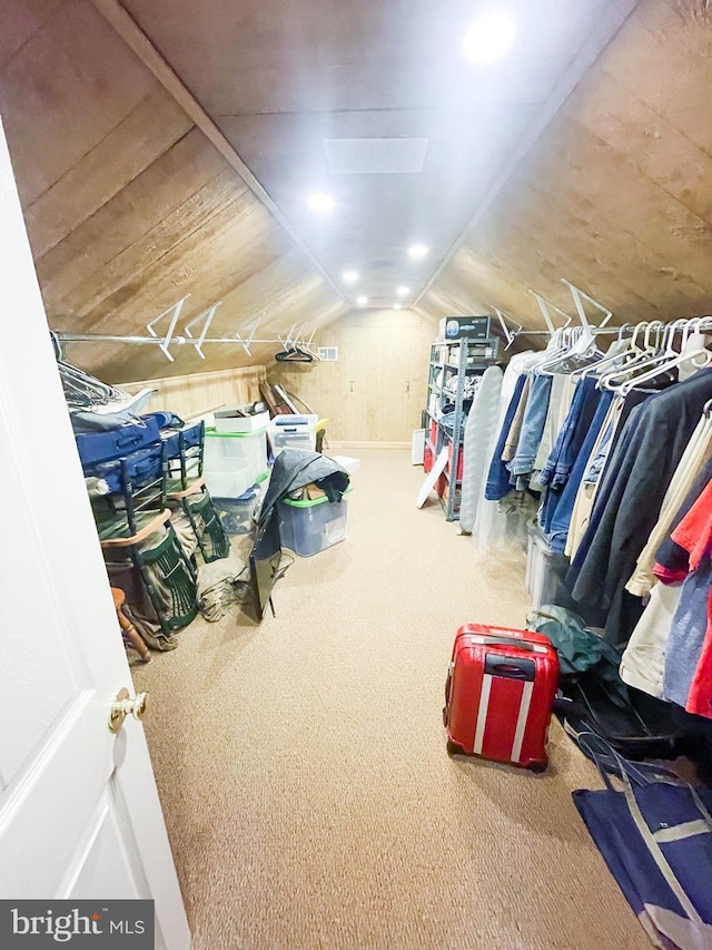 walk in closet featuring lofted ceiling and carpet floors