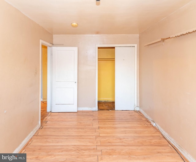 unfurnished bedroom featuring a closet and light hardwood / wood-style flooring