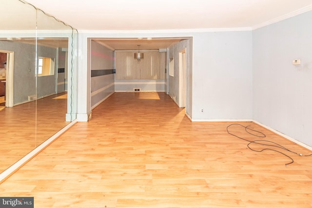 spare room with ornamental molding and wood-type flooring