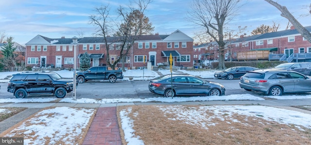 view of snow covered parking area