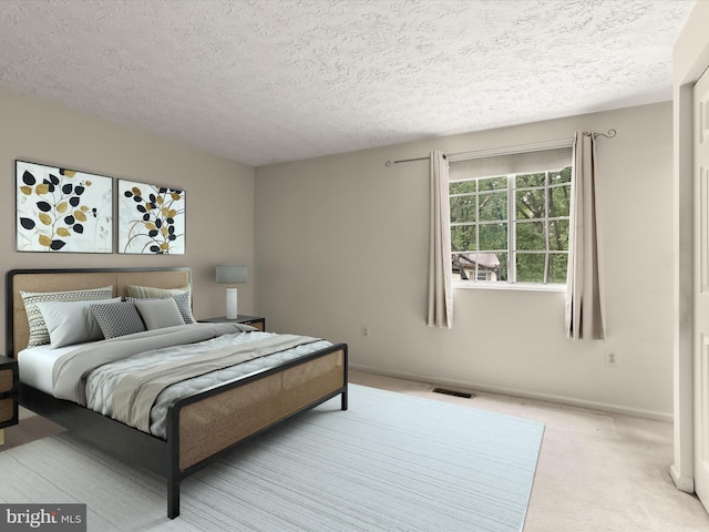 bedroom featuring a textured ceiling, carpet, and baseboards