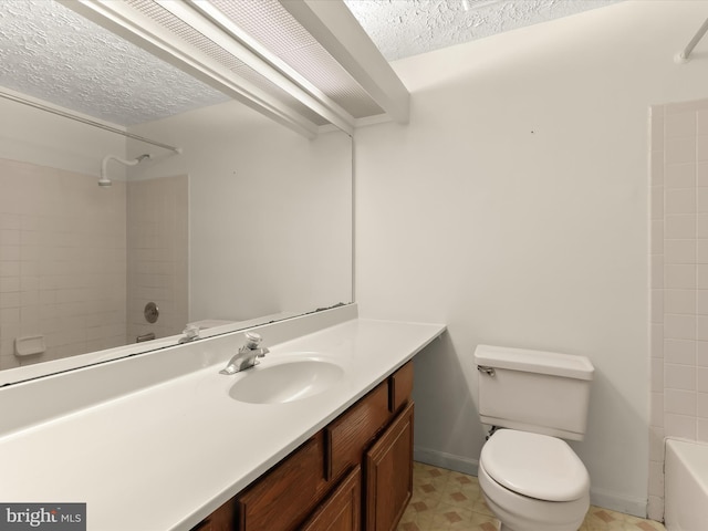full bathroom featuring a textured ceiling, shower / washtub combination, toilet, and vanity