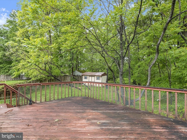 deck featuring an outdoor structure and a storage unit