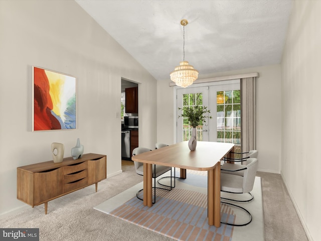 carpeted dining space with a chandelier, baseboards, and lofted ceiling