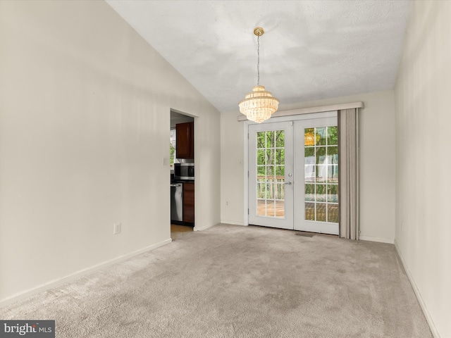 empty room featuring a chandelier, light colored carpet, baseboards, and french doors