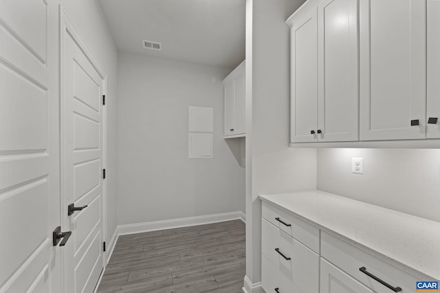 clothes washing area featuring light wood-type flooring