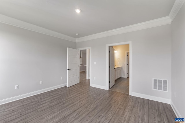 unfurnished room with wood-type flooring and ornamental molding