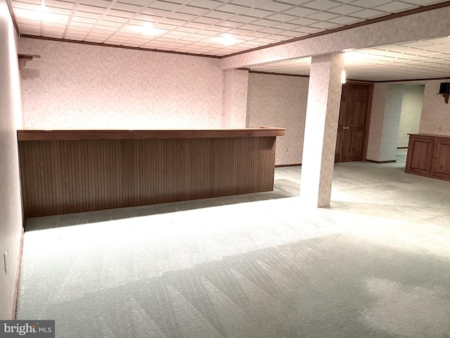 basement with light colored carpet and indoor bar