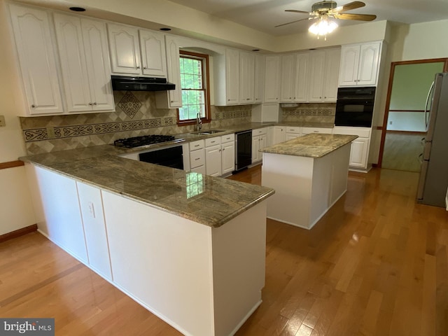 kitchen featuring stone counters, tasteful backsplash, black appliances, white cabinets, and kitchen peninsula