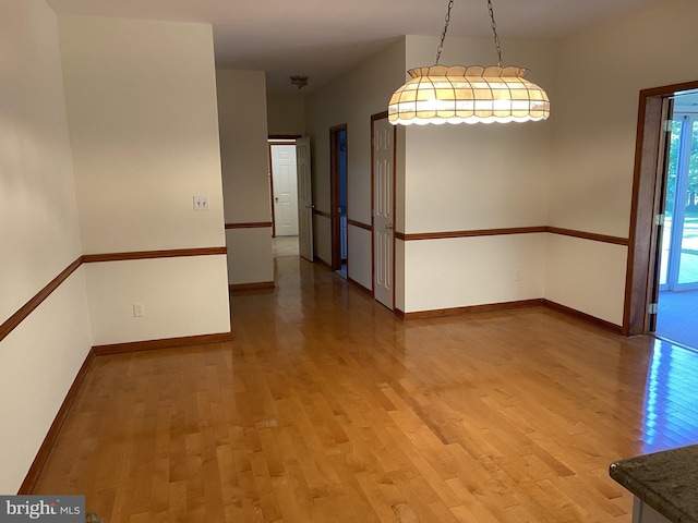 unfurnished room with wood-type flooring