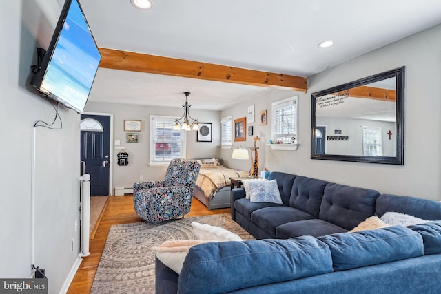 living room featuring a baseboard radiator, plenty of natural light, beam ceiling, and light hardwood / wood-style floors