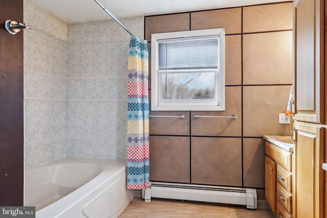 bathroom with a baseboard radiator, tile walls, vanity, and shower / tub combo with curtain