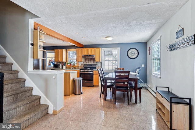 dining space with beamed ceiling and a textured ceiling