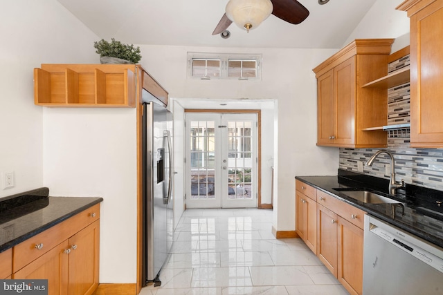 kitchen with sink, appliances with stainless steel finishes, french doors, decorative backsplash, and dark stone counters