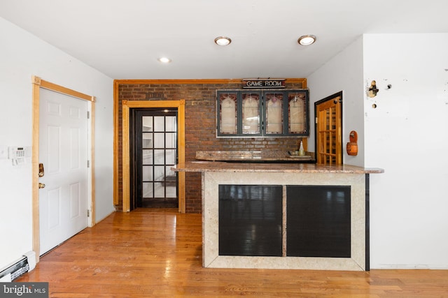 interior space featuring hardwood / wood-style flooring and baseboard heating