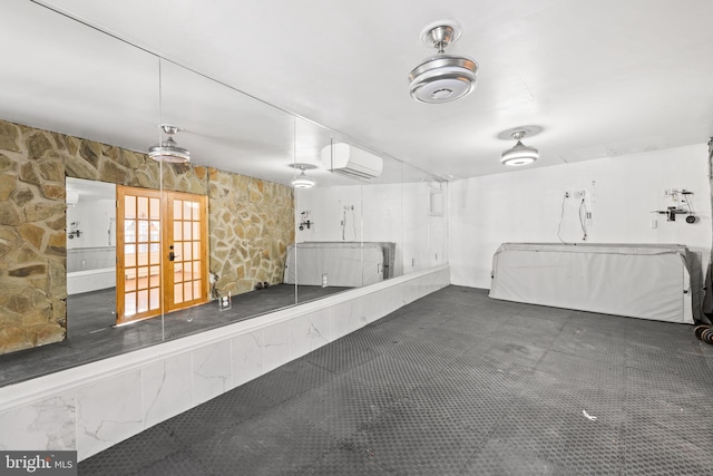 garage with an AC wall unit and french doors