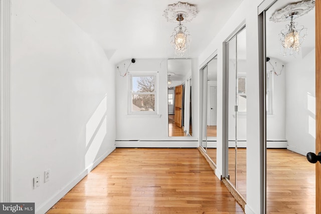 entryway featuring an inviting chandelier and light hardwood / wood-style floors