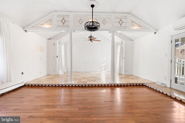 unfurnished living room with lofted ceiling, light hardwood / wood-style flooring, ceiling fan, a wall mounted AC, and ornate columns