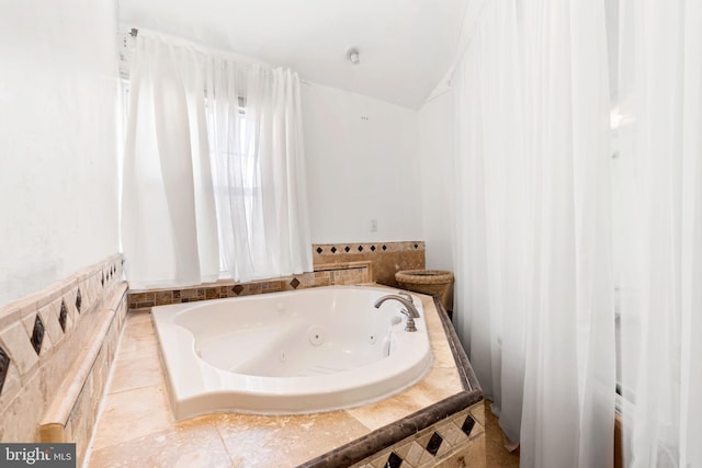 bathroom featuring a relaxing tiled tub