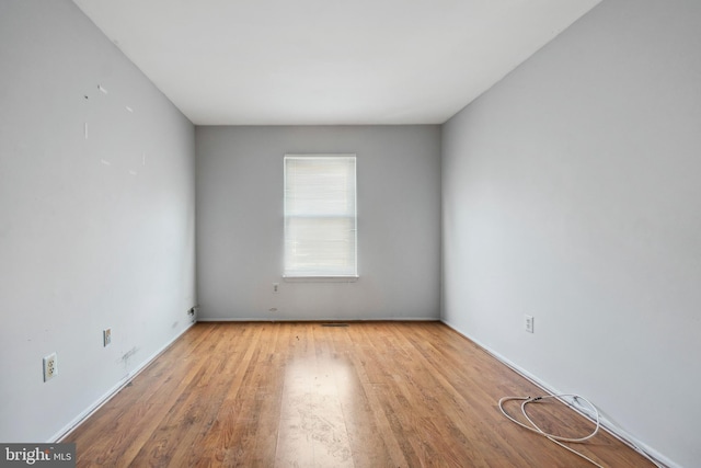 empty room with light hardwood / wood-style flooring